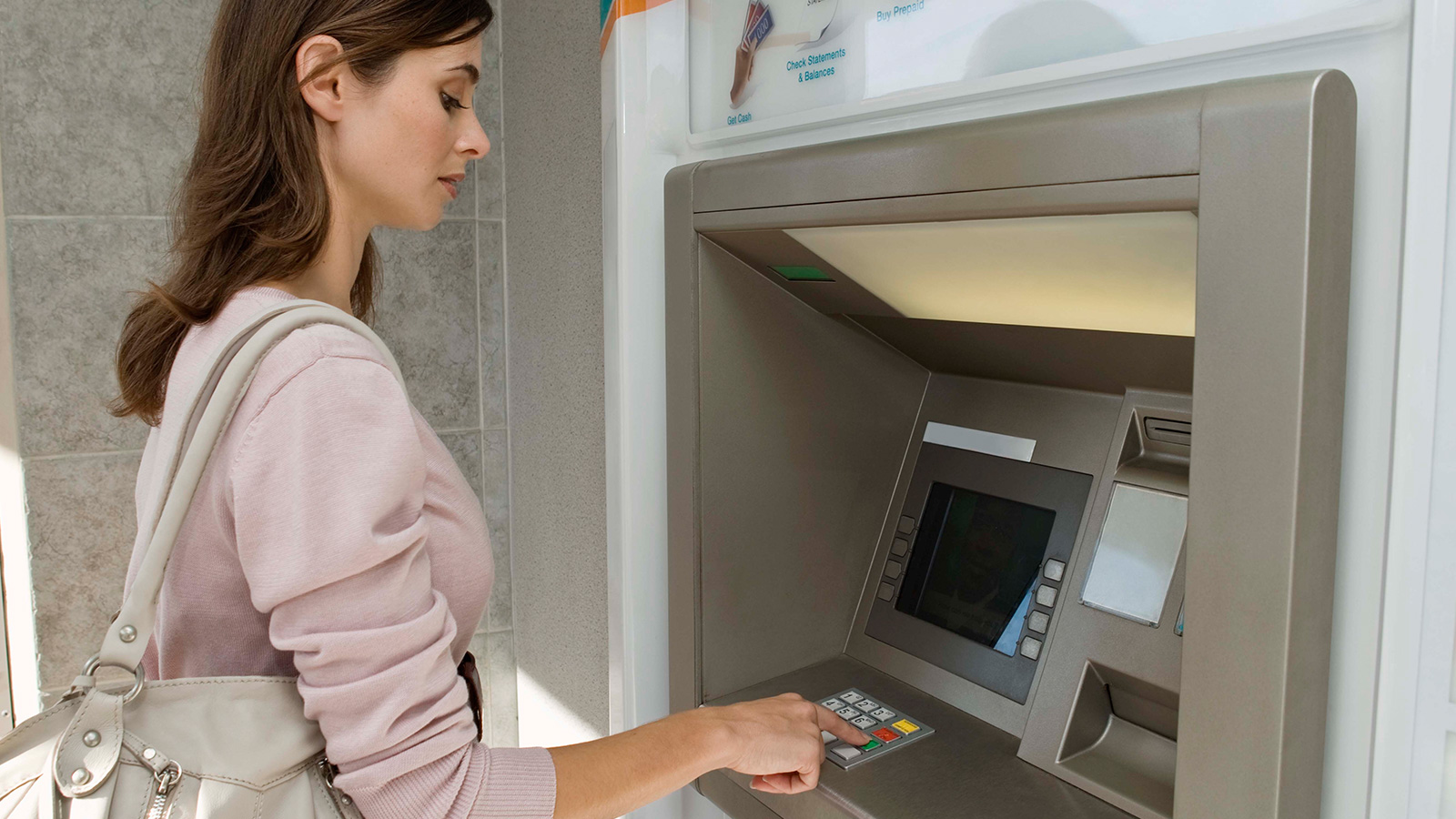 Woman at ATM Woman using ATM.