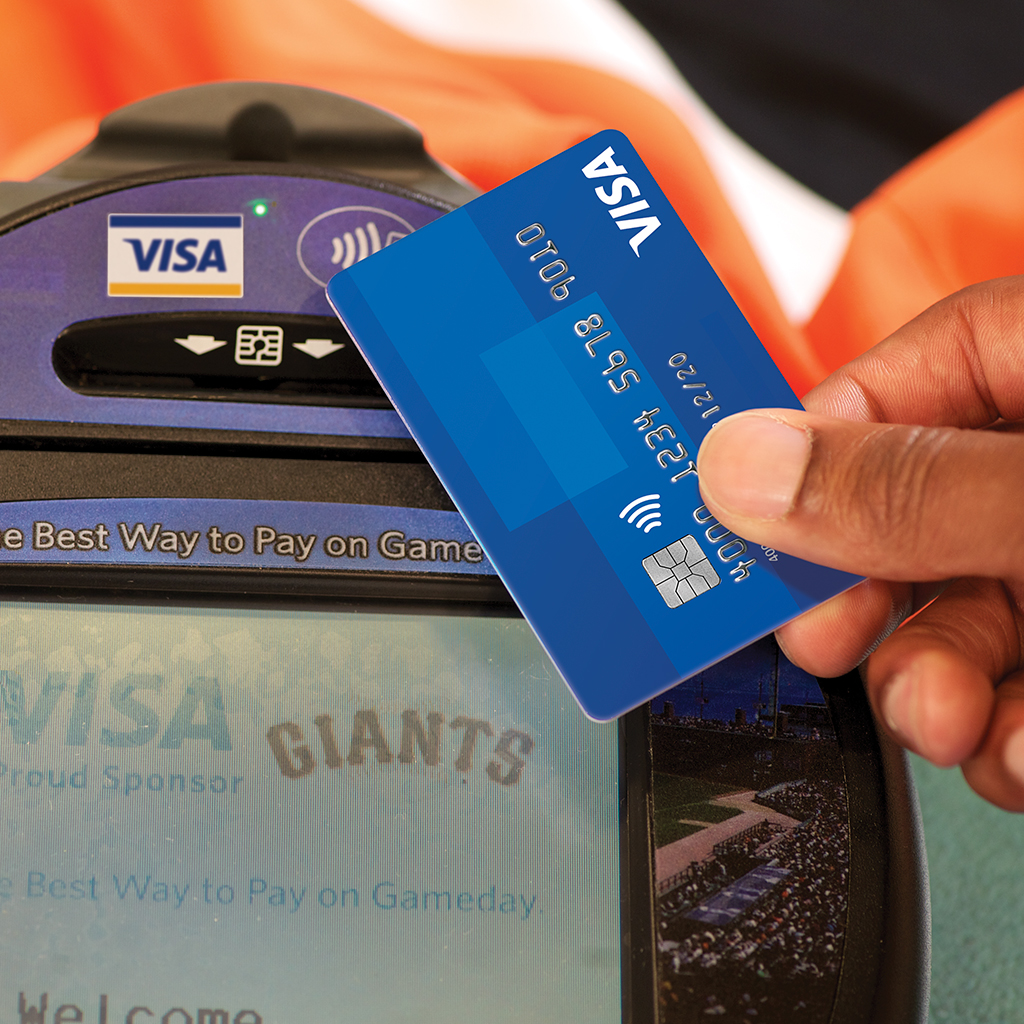 Close up of contactless Visa credit card payment.