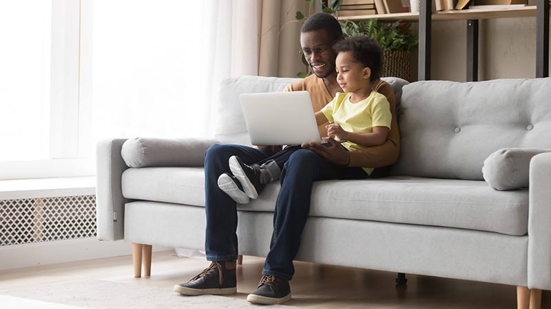 Father and son using laptop